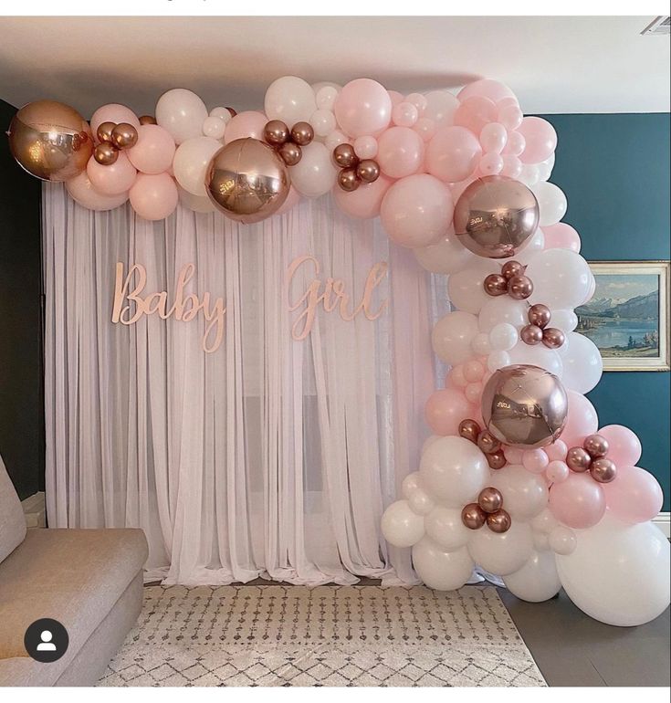 the balloon arch is decorated with pink, gold and white balloons for a baby girl shower