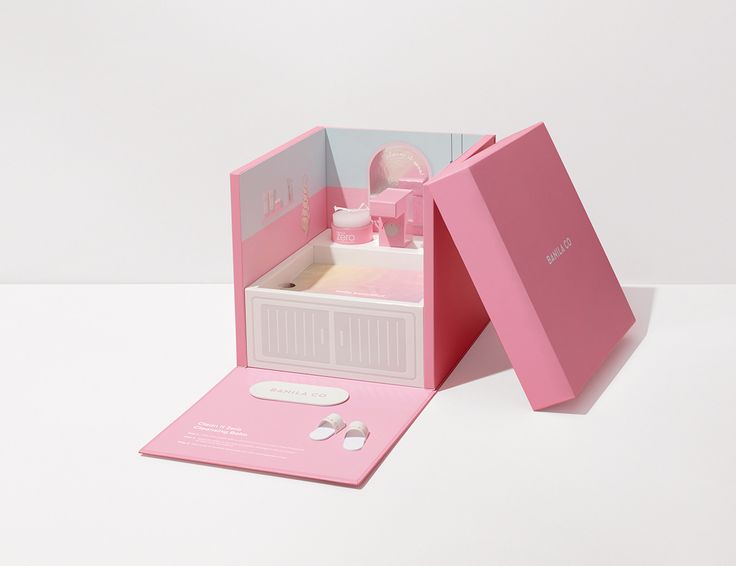 an open pink box with a doll in it on a white table and the inside is empty