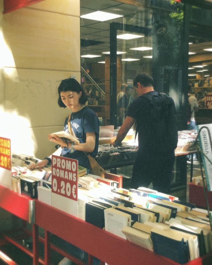 a man and woman looking at books in a book store