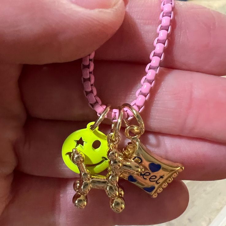 Pink Enamel , Magnetic Good Clasp With 3 Inch Extender, Yellow Smiley Face Charm, Gold Candy Charm, Gold Balloon Dog Charm, Brand New Never Worn . Trendy Pink Adjustable Charm Necklace, Fun Pink Adjustable Charm Necklace, Pink Adjustable Fun Charm Necklace, Fun Pink Adjustable Charm Necklaces, Adjustable Gold Charm Necklaces With Playful Style, Playful Gold Charm Necklace With Adjustable Fit, Pink Adjustable Charm Necklace For Birthday, Gold Balloon Dog, Shiny Happy People