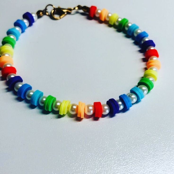 a multicolored beaded bracelet on a white surface