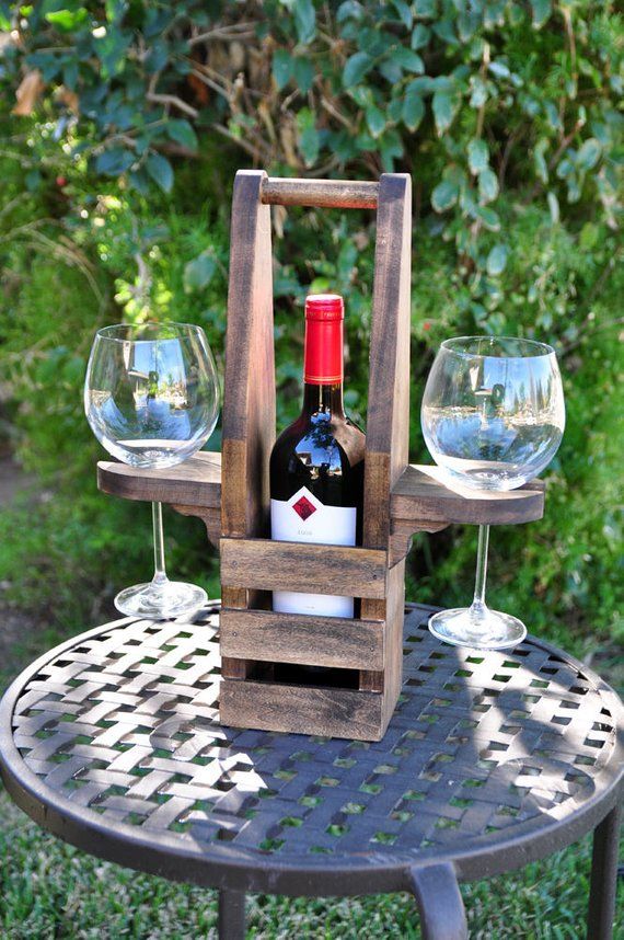 a bottle of wine sitting on top of a table next to two empty wine glasses