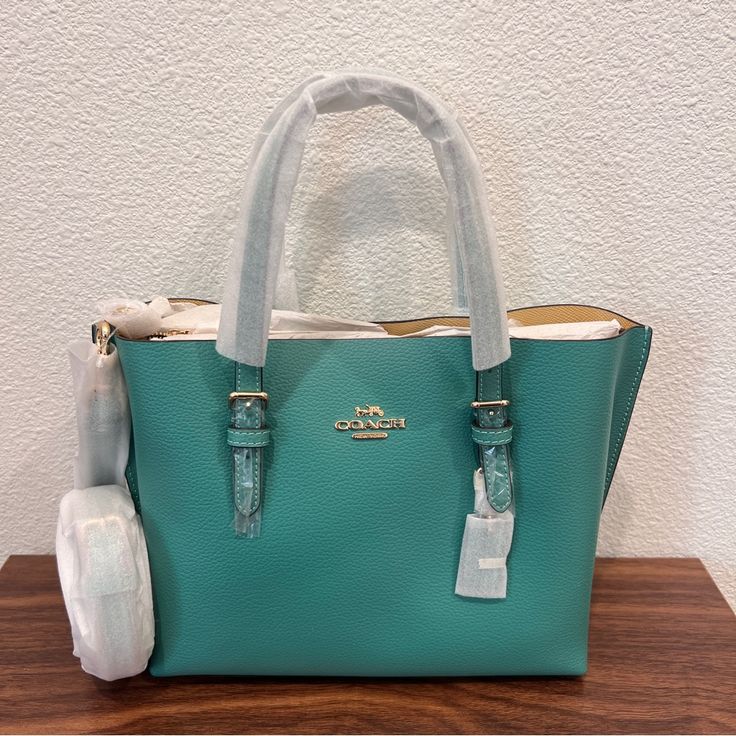 Color Green Vanilla Cream Double Face Leather Zip-Top Closure, Fabric Lining Side Open Compartments Handles With 4 3/4" Drop Detachable Strap With 22" Drop For Shoulder Or Crossbody Wear 9 3/4" (L) X 7 1/2" (H) X 4 3/4" (W) Style No. C4084 Green Tote Bags, Coach Mollie Tote, Coach Travel Bag, Coach Zip Top Tote, Paw Wallpaper, Canvas Leather Tote Bag, Coach Leather Bag, Plaid Tote, Canvas Leather Tote