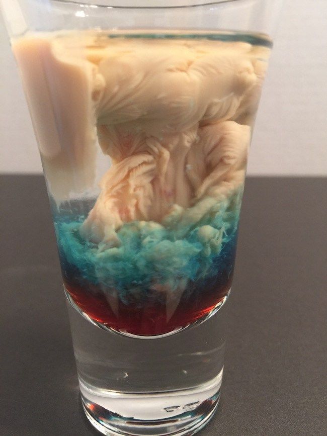 a glass filled with blue and red liquid