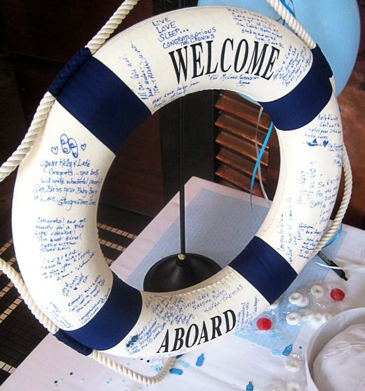 a life preserver sitting on top of a table next to a sign that says welcome aboard