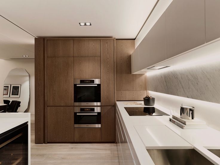 a modern kitchen with wooden cabinets and white counter tops