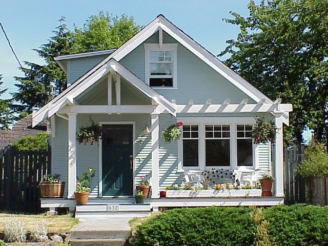 a small house with white trim and windows