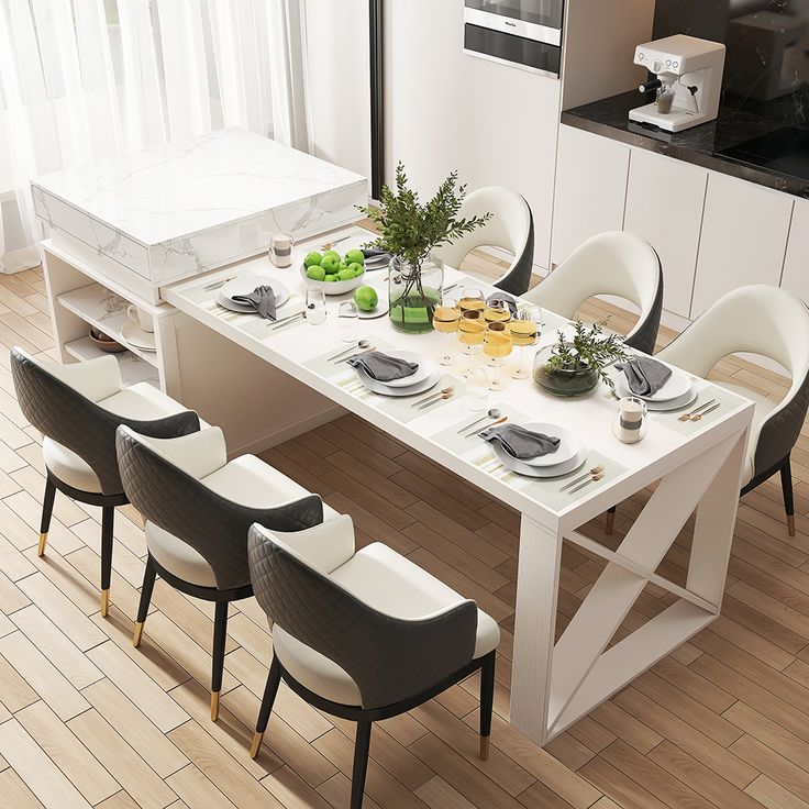 a dining room table set for six with white chairs and place settings on the table