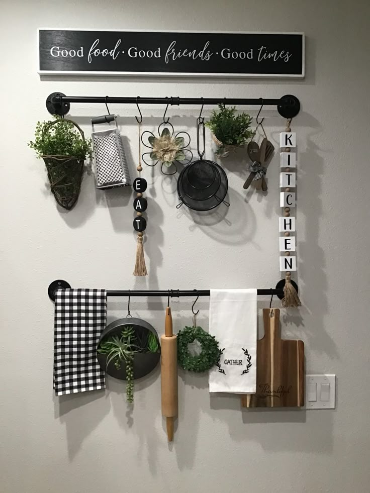 a kitchen wall with pots and pans hanging from it's hooks on the wall