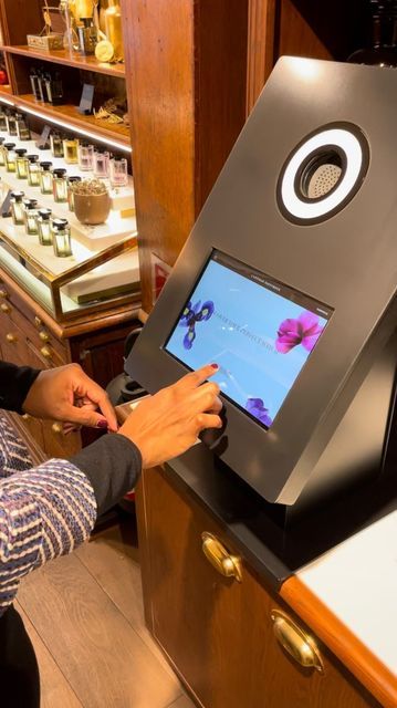 a woman is using an interactive device to check out the products on display at a store