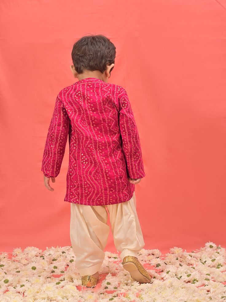 VASTRAMAY SISHU Boys' Pink Bandhni Kurta And Patiala Set Dress your little one in style and tradition with this vibrant pink kurta patiala set. Featuring a beautiful bandhani print, the kurta boasts a comfortable relaxed fit and a mandarin collar. The set comes complete with cream colored patiala pants for a complete and festive look. Key Features Pink Bandhni Print Mandarin Collar Kurta Relaxed Fit Cream Patiala Pants Elasticated Waistband for Comfort Specifications Material: Kurta - Rayon, Pat Pink Kurta For Festivals With Traditional Drape, Navratri Pink Kurta With Traditional Drape, Traditional Drape Pink Kurta For Festivals, Pink Bollywood Kurta For Navratri, Pink Cotton Traditional Wear With Dabka, Pink Sherwani With Gota Work For Diwali, Traditional Pink Sherwani For Diwali, Traditional Pink Sherwani For Festivals, Festive Pink Sherwani With Gota Work