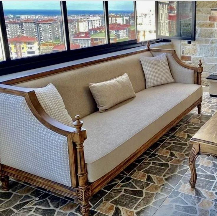 a living room filled with furniture and a fire place in front of a large window