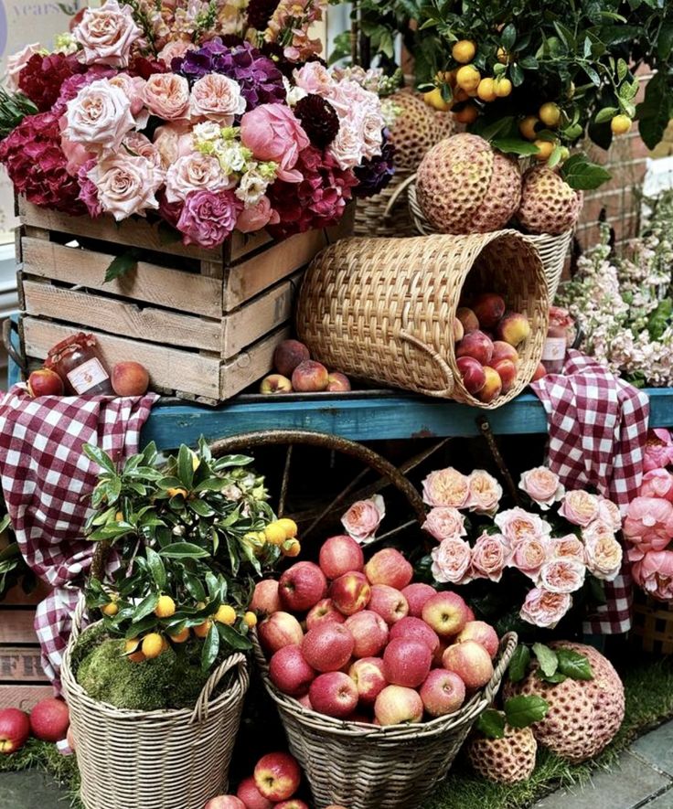 several baskets filled with flowers and apples