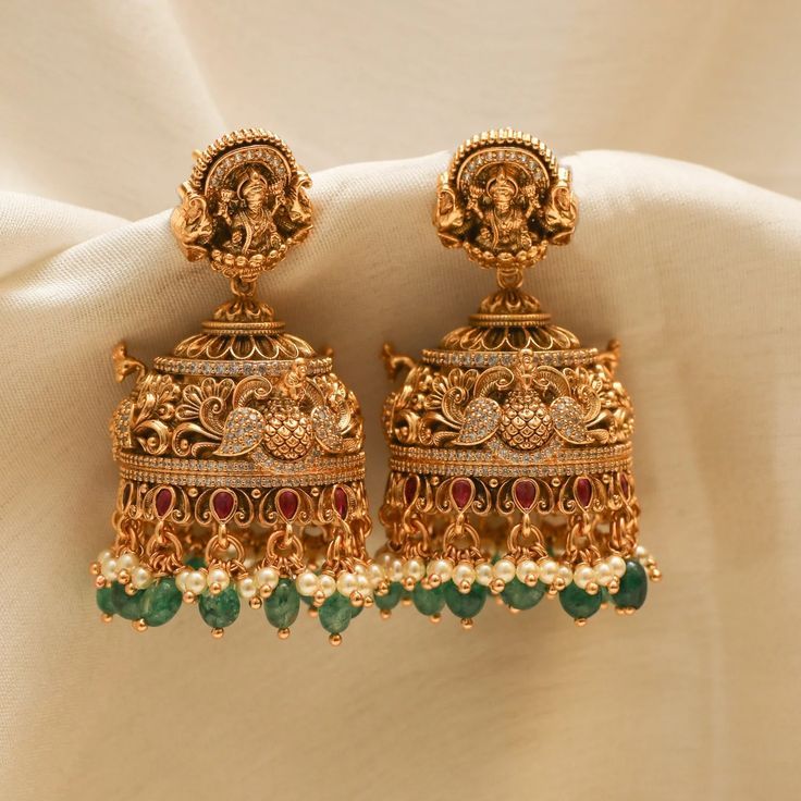 Show off India's culture and tradition by wearing perfectly handcrafted temple jewellery jhumkas! Explore our temple jewellery collection! Latest Design Earrings Gold, Gold Wedding Earrings Indian, Lakshmi Jhumkas Gold, Gold Antique Jhumkas, Cz Earrings Indian Gold, Temple Jewellery Earrings Antique, Jumka Earrings Gold Indian Jewelry, Temple Earrings Gold Jewelry, Antique Gold Jhumka