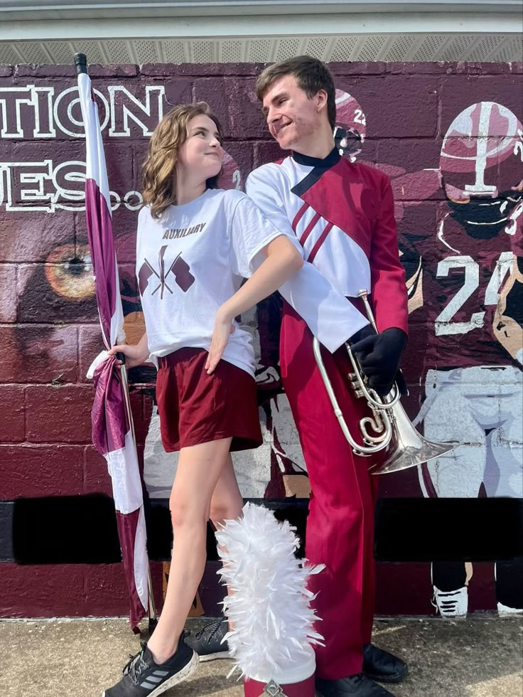 a man and woman are dressed up as marching players