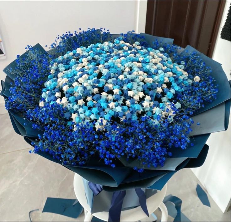 a bouquet of blue and white flowers on a table