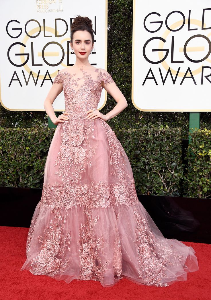 an image of a woman in a pink dress on the red carpet at golden globe awards