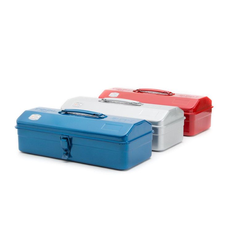 three different colored lunch boxes sitting next to each other