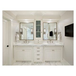 a large bathroom with double sinks and two mirrors on the wall next to each other