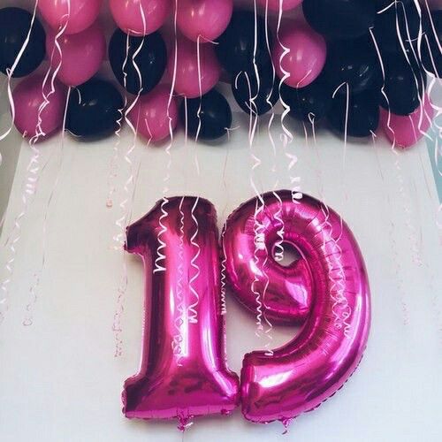 the number 19 balloon is pink and black