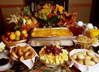 a table filled with lots of different types of foods and desserts on top of it