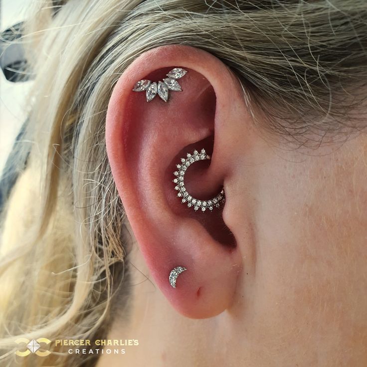 a close up of a person with ear piercings on their ears and behind the ear