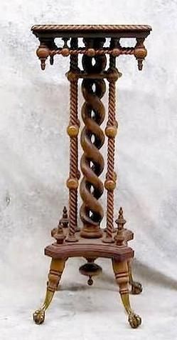 an ornate wooden stand with spiral designs on it