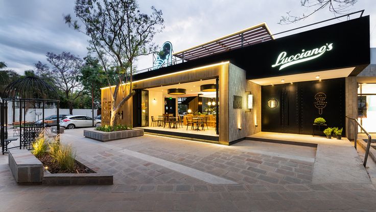 the exterior of a restaurant that is lit up at night