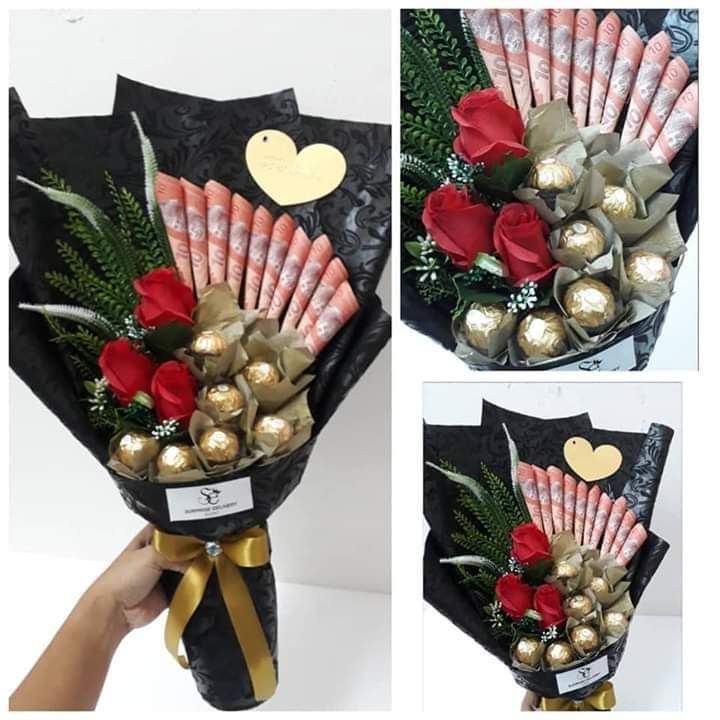 a bouquet of roses and chocolates wrapped in black paper with gold foil wrappers