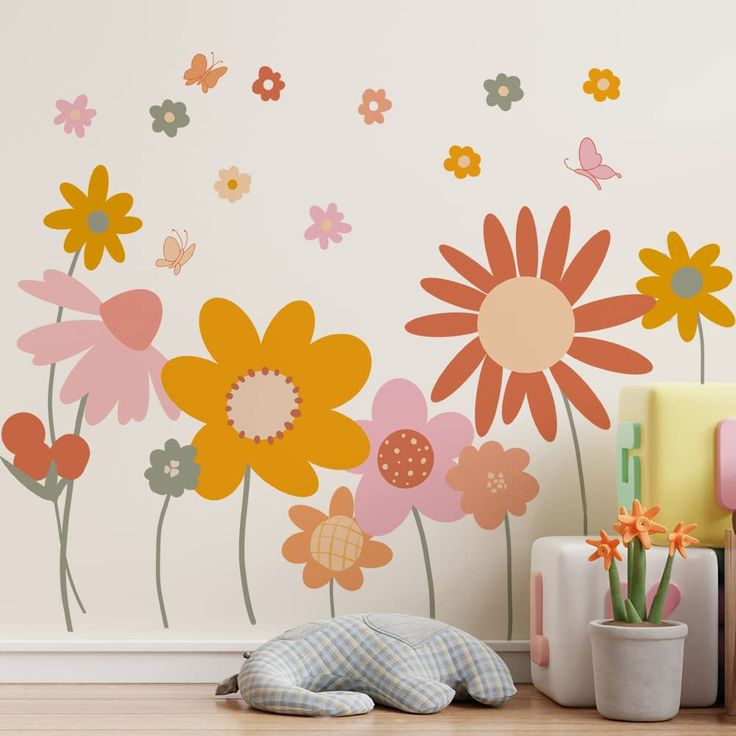 a wall with flowers and butterflies painted on it in a child's playroom