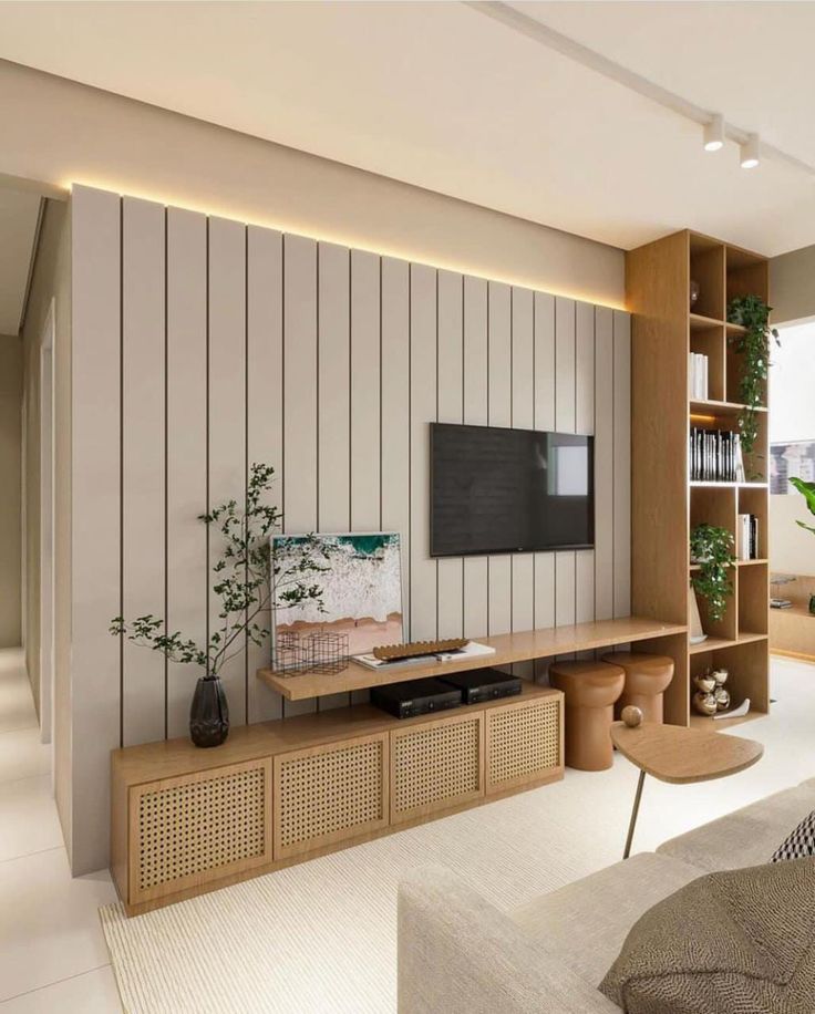 a living room filled with furniture and a flat screen tv on top of a wooden shelf