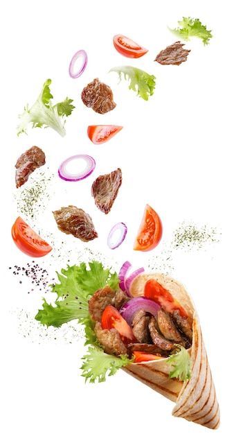 a sandwich with meat, lettuce and tomatoes falling into the air on white background