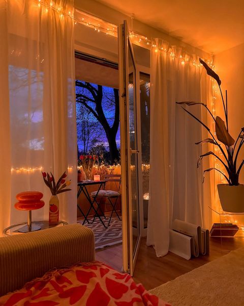 a living room filled with furniture and lots of lights on the windows sills