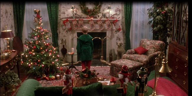 a living room decorated for christmas with green furniture and holiday decorations on the fireplace mantel