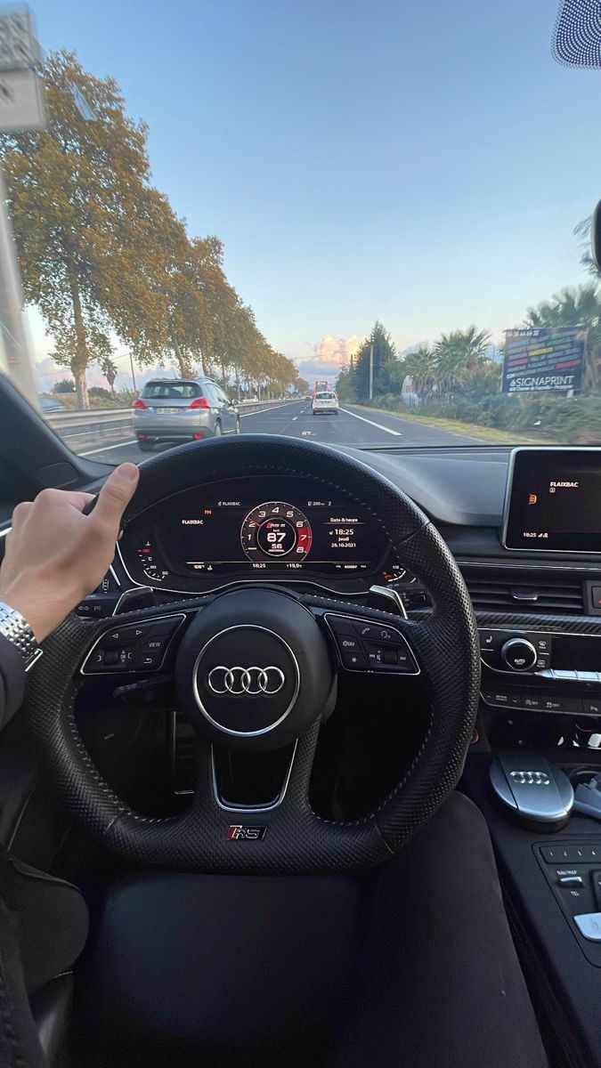 the interior of an audi car with dashboard and steering wheel, including touchscreens