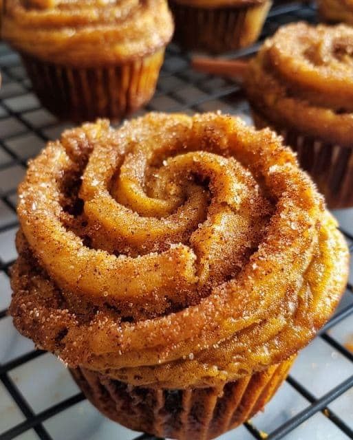 some cinnamon rolls are cooling on a rack