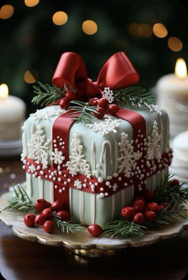 a decorated christmas cake on a plate with candles in the background