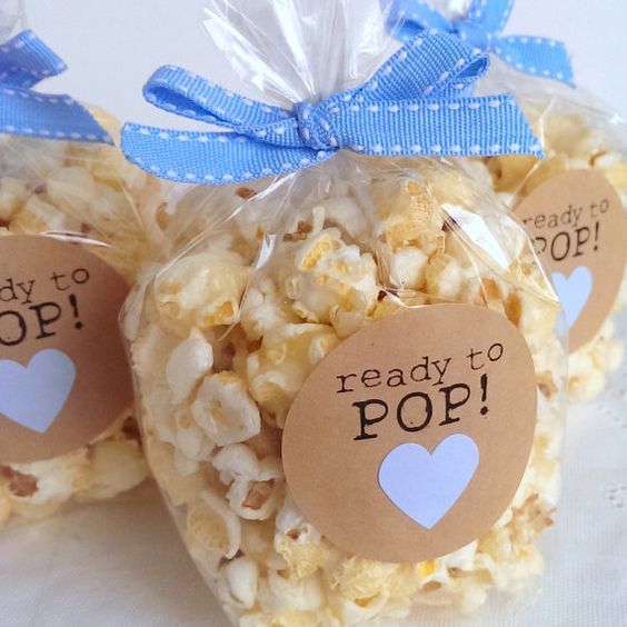 three bags filled with popcorn sitting on top of a table