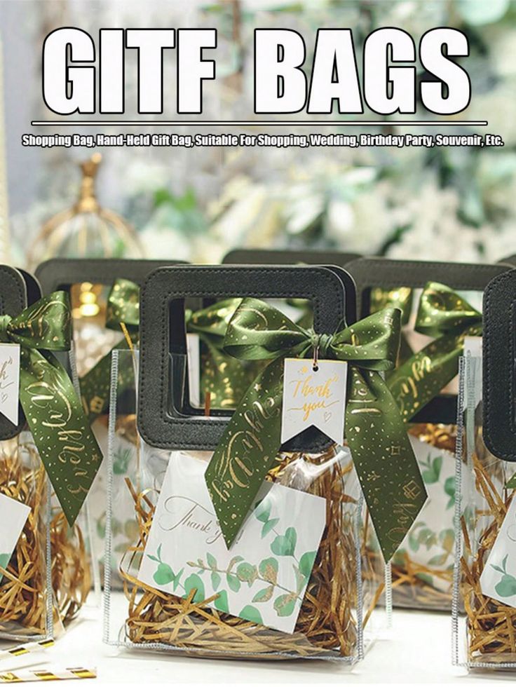 four clear gift bags with green bows and tags on them are sitting in small glass vases