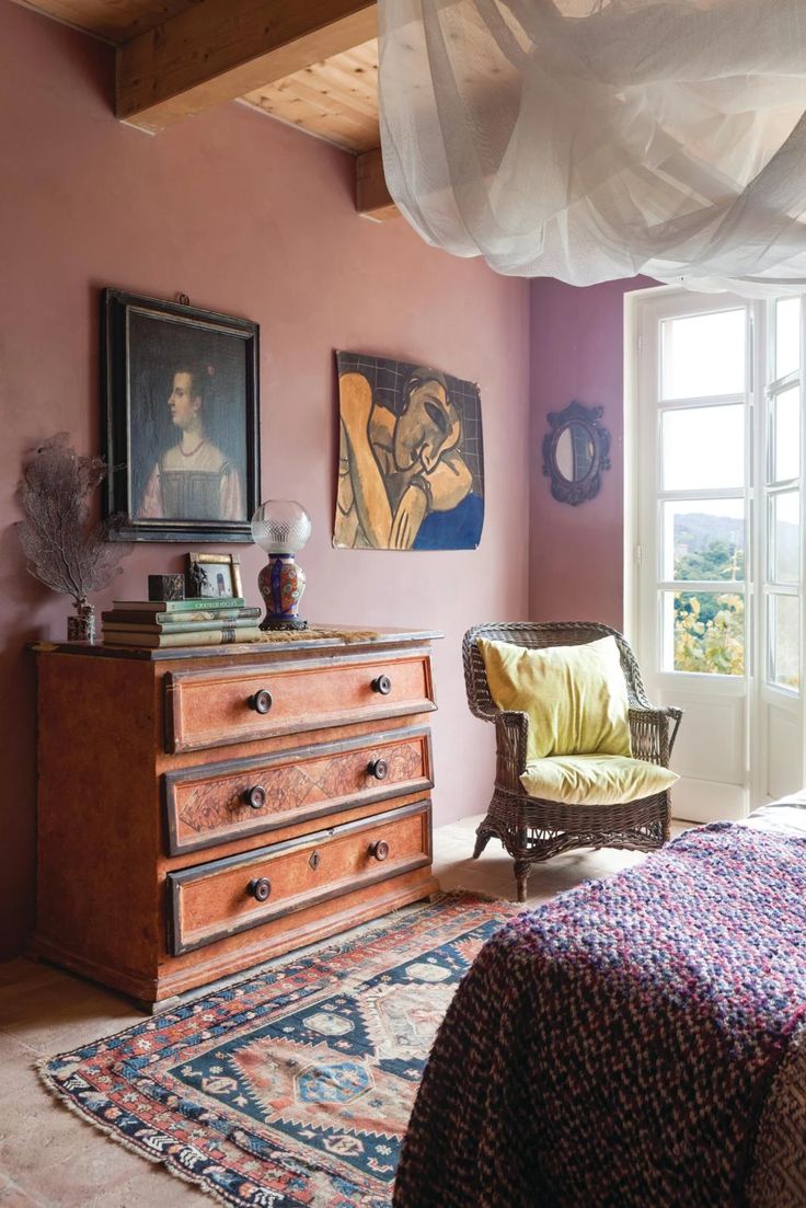 a bedroom with a bed, dresser and chair next to an open window in the room