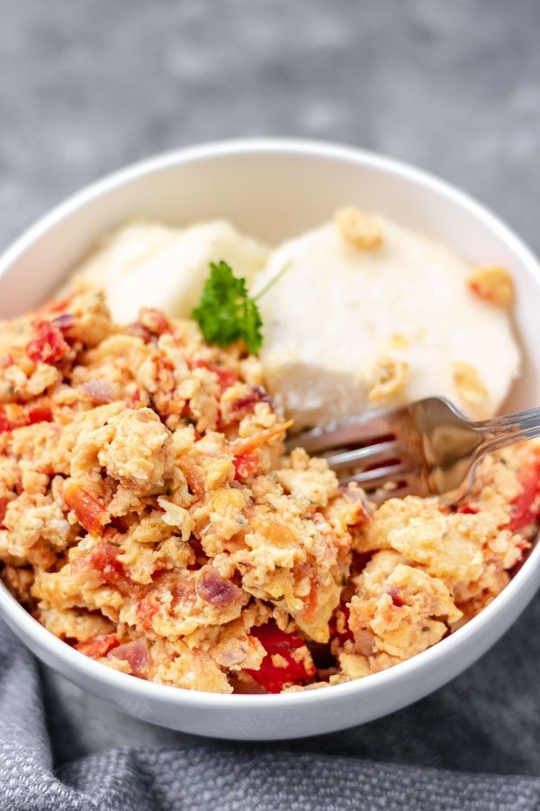 a white bowl filled with food on top of a table