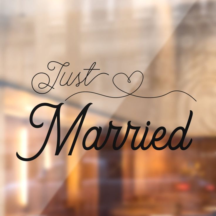 the words just married written in black on a glass window