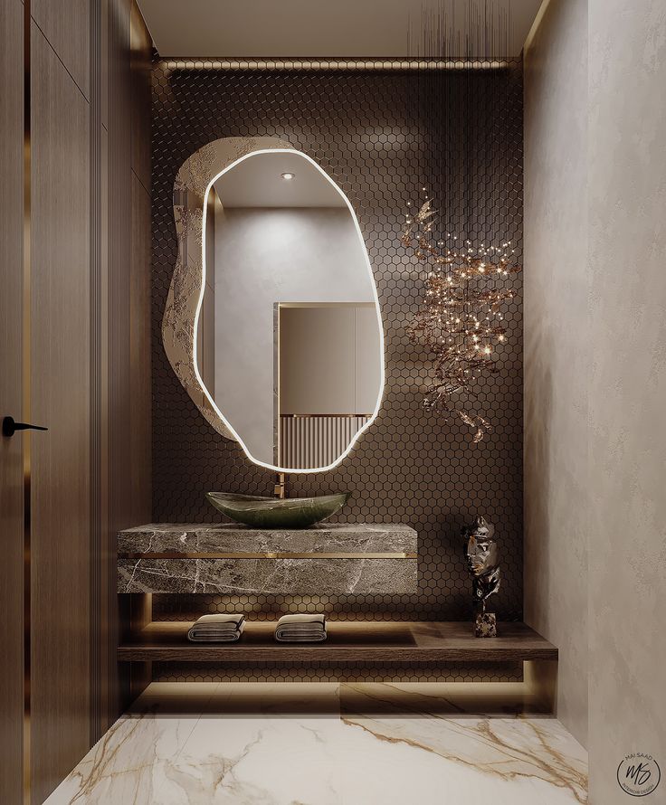 a bathroom with marble counter tops and a round mirror