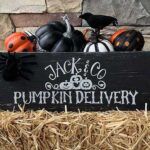 a wooden sign that says jack and co pumpkin delivery on top of hay bales