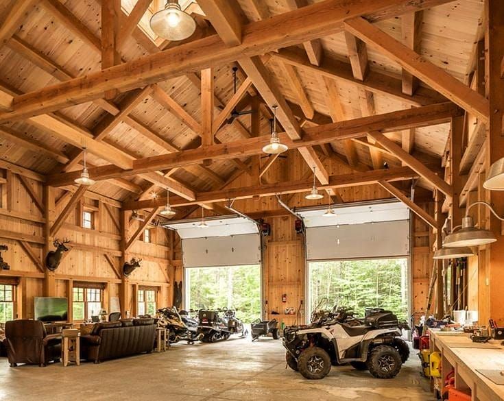 a large wooden building with several vehicles in it