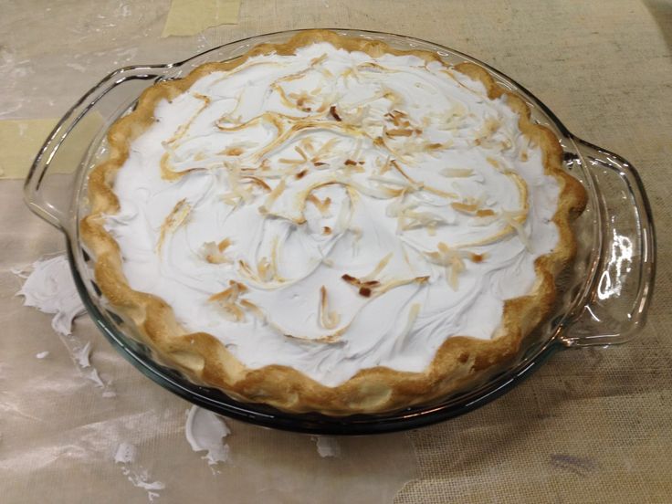 a pie sitting on top of a table covered in frosting