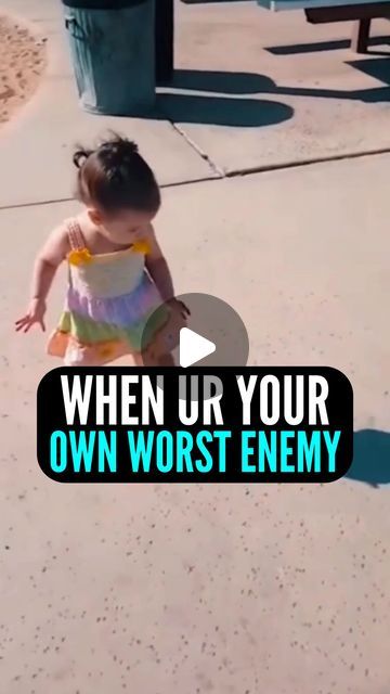 a toddler is playing with a frisbee on the sidewalk