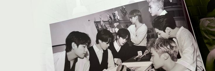 black and white photograph of young men sitting at desk