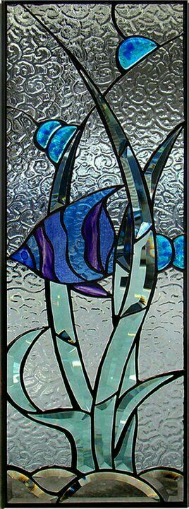 a stained glass window with blue and purple fish