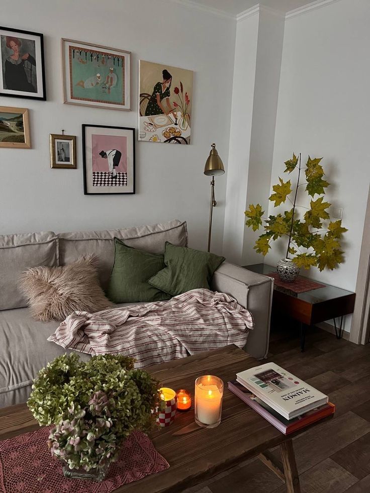 a living room filled with lots of furniture and pictures on the wall above it's coffee table